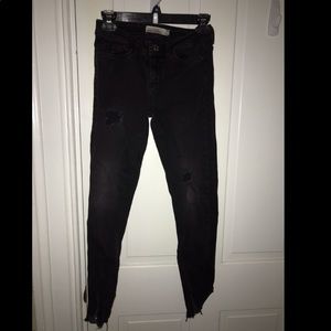 Black denim jeans with distressed marks